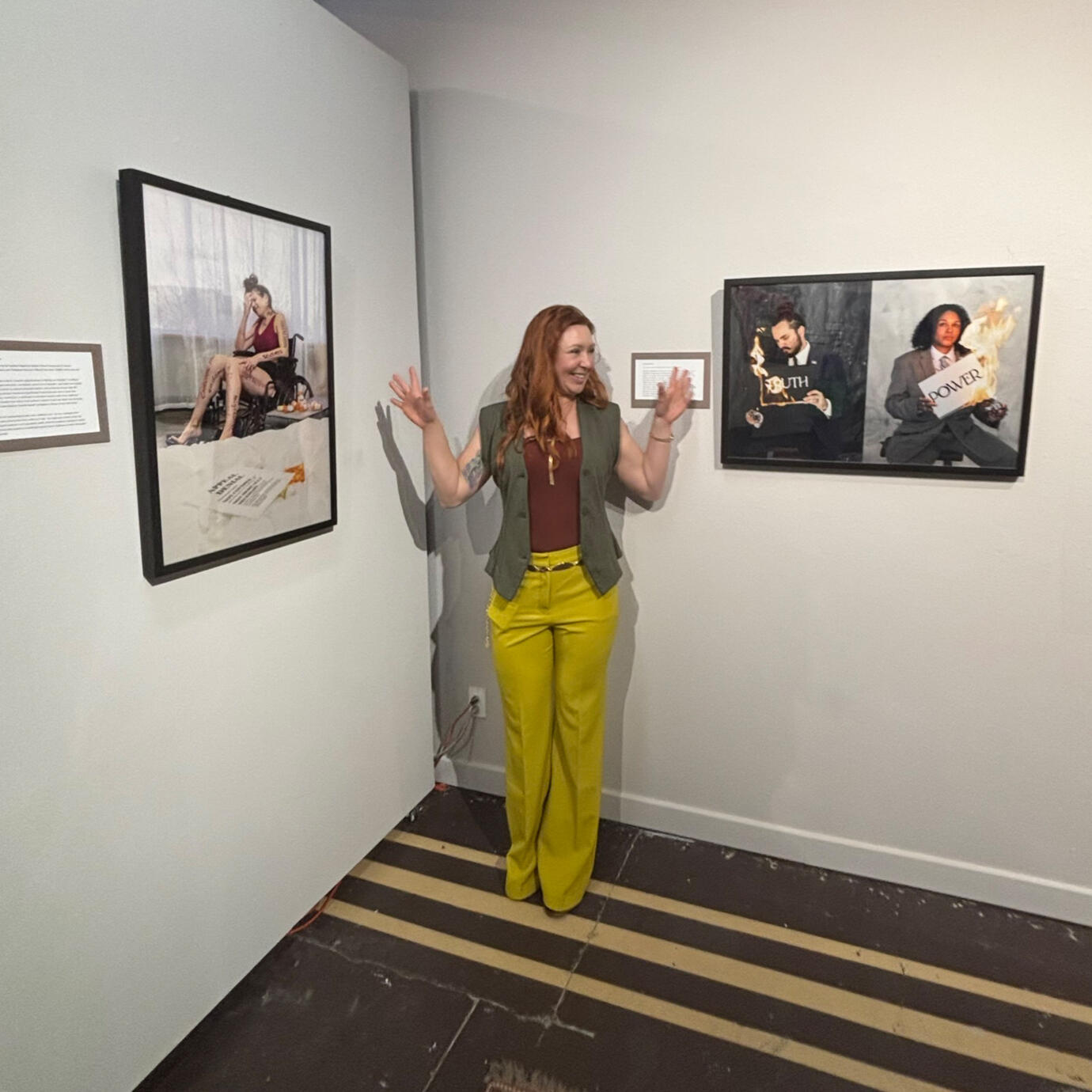 Savanna Goodman with Her Published Photography Photographer Savanna Goodman standing beside a gallery display of her conceptual photography