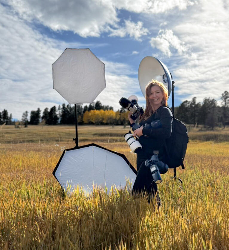 Breckenridge Photographer Savanna Goodman | Behind the Scenes Breckenridge photographer Savanna Goodman carrying professional cameras and lighting equipment through a Colorado mountain meadow